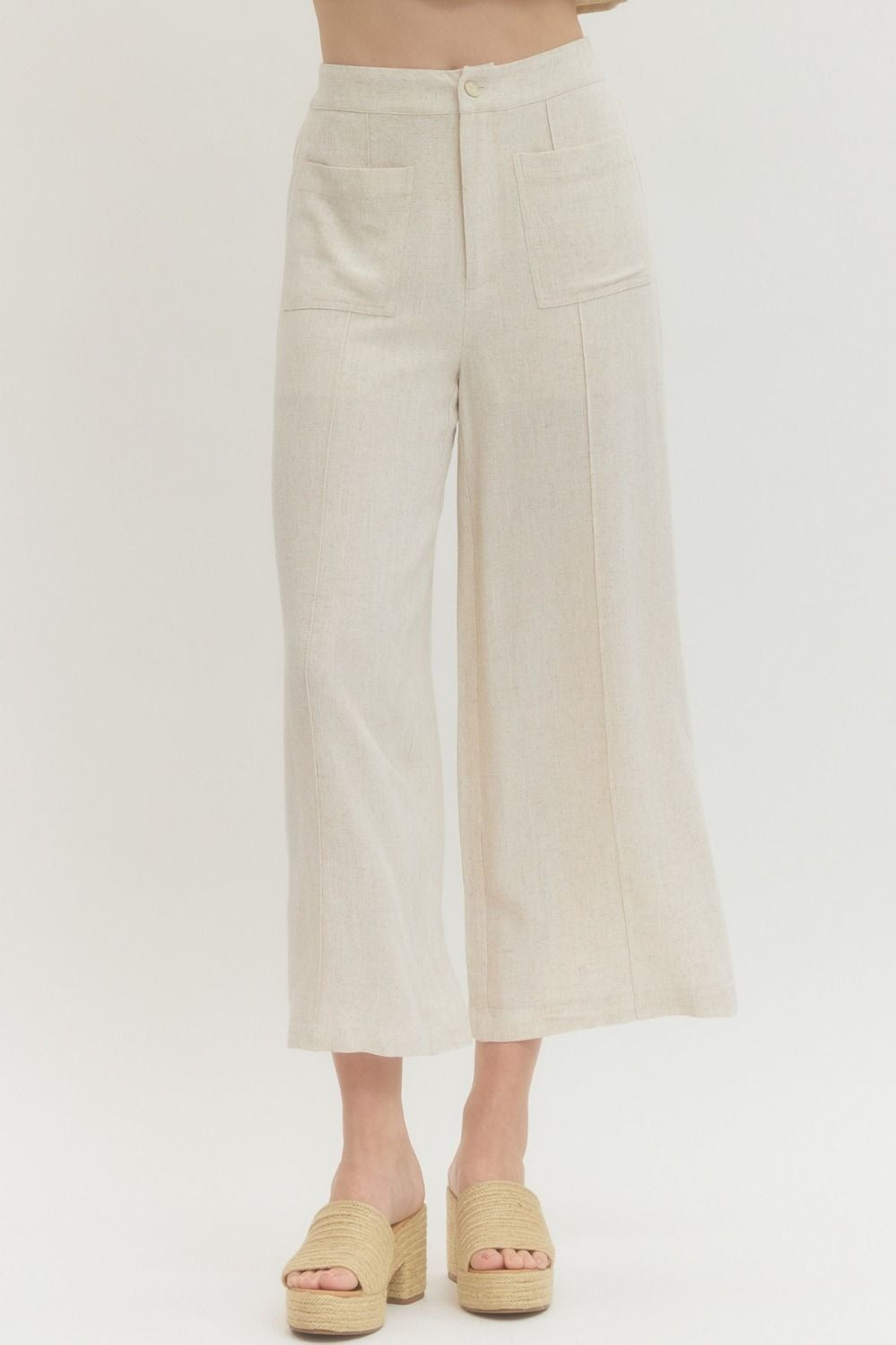 Solid woven pants featuring front patch pockets and zip-fly with button closure