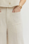Solid woven pants featuring front patch pockets and zip-fly with button closure