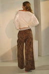 Leopard print wide-leg pants featuring an elastic waistband with button detail and relaxed fit
