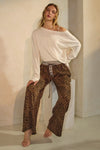 Leopard print wide-leg pants featuring an elastic waistband with button detail and relaxed fit
