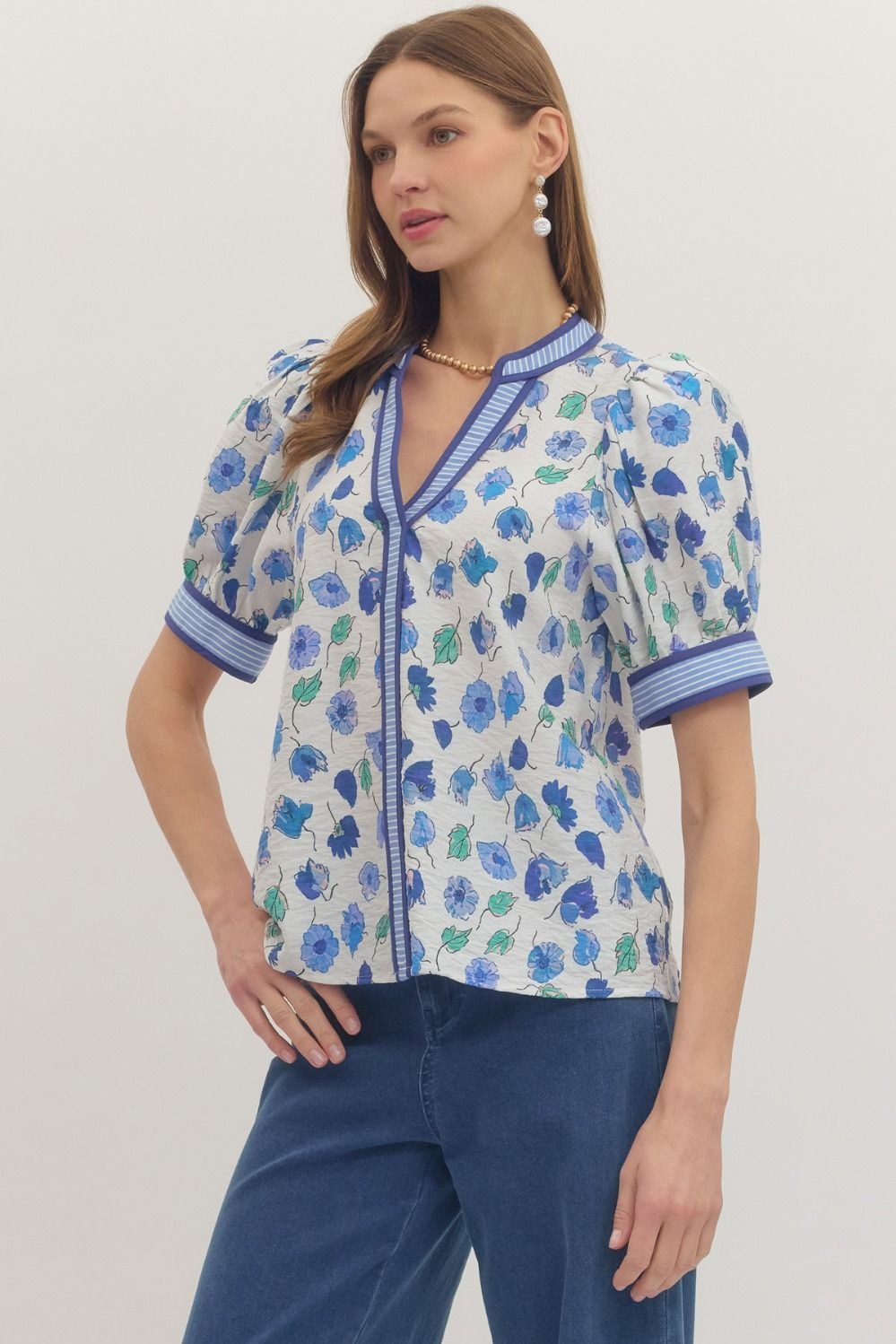 Floral print short puff sleeve top featuring contrast striped binding along V-neck