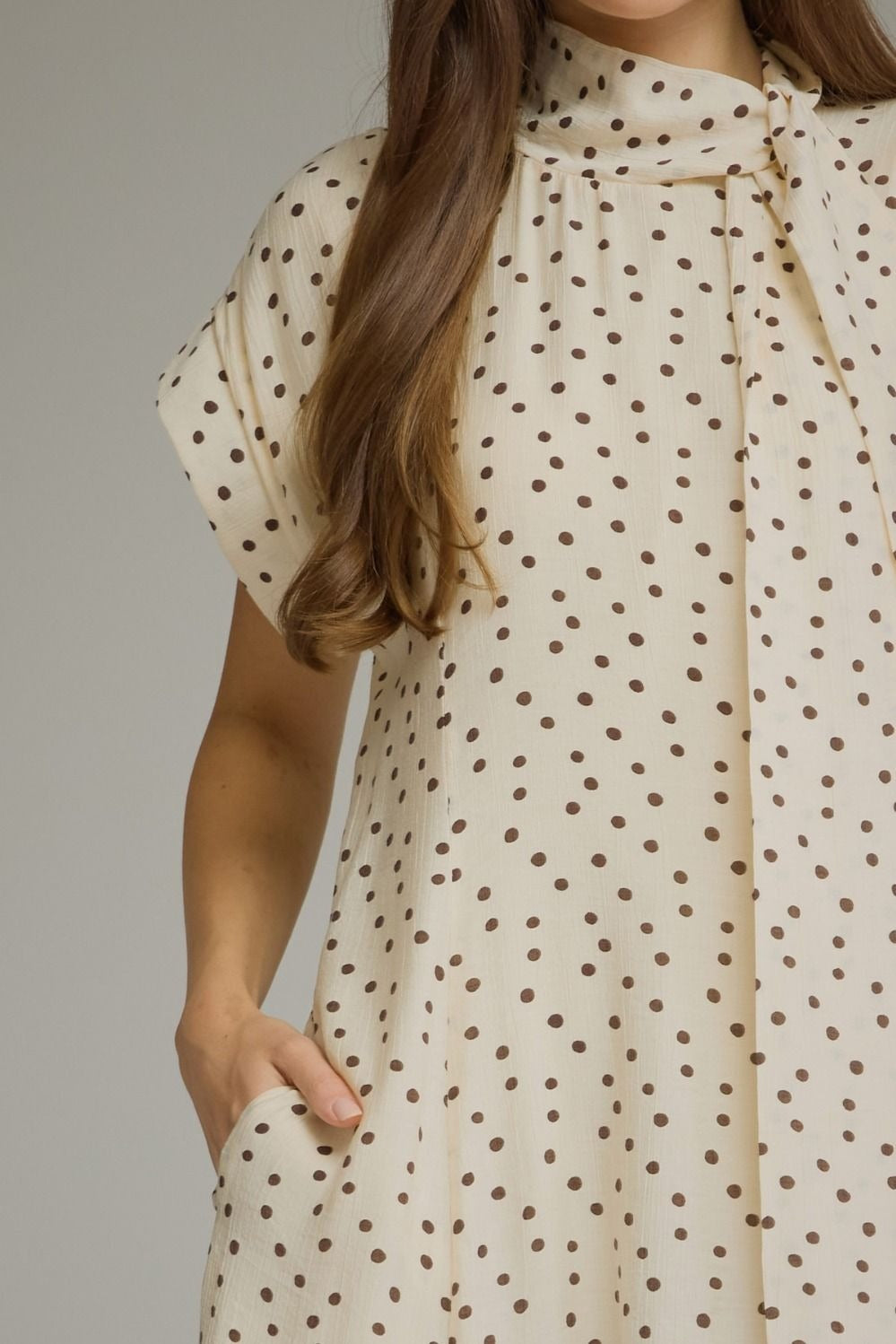 Polka dot short sleeve midi dress featuring a self-tie neck