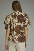 Printed short puff sleeve top featuring button closure at front