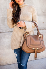 Tan purse with neutral-colored outfit