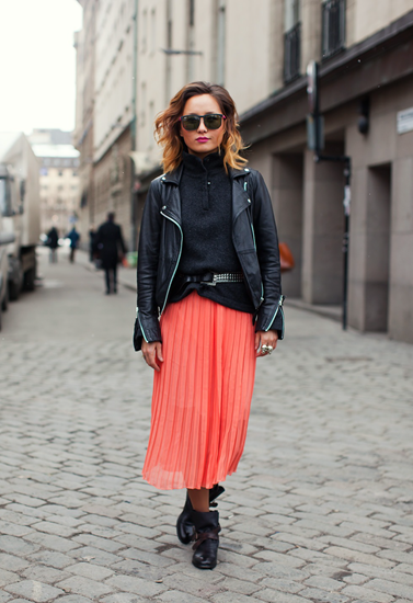 Living coral pleated skirt with edgy black top and leather jacket